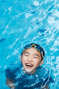 Happy Asian Kid in the Swimming Pool