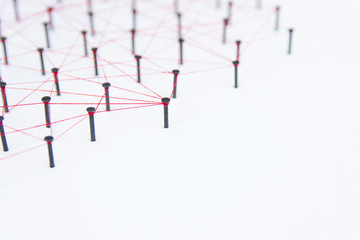 Linking entities, social media, Communications Network, The connection between the two networks. Network simulation on white paper linked together with a red thread with copy space