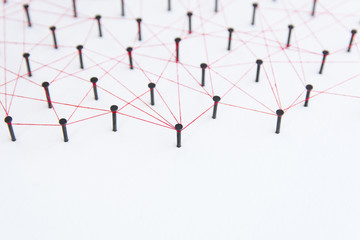 Linking entities, social media, Communications Network, The connection between the two networks. Network simulation on white paper linked together with a red thread with copy space