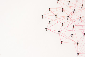Linking entities, social media, Communications Network, The connection between the two networks. Network simulation on white paper linked together with a red thread with copy space