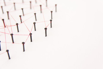 Linking entities, social media, Communications Network, The connection between the two networks. Network simulation on white paper linked together with a red thread with copy space