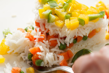 Rise basmati with vegetables. Vegan food. Basmati rice cooked white on wooden table.