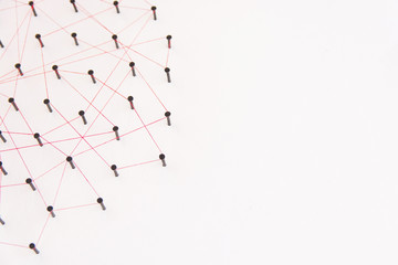 Linking entities, social media, Communications Network, The connection between the two networks. Network simulation on white paper linked together with a red thread with copy space