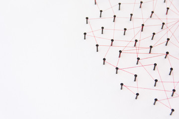 Linking entities, social media, Communications Network, The connection between the two networks. Network simulation on white paper linked together with a red thread with copy space