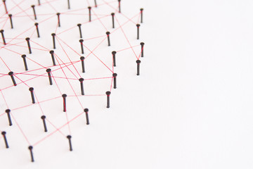 Linking entities, social media, Communications Network, The connection between the two networks. Network simulation on white paper linked together with a red thread with copy space