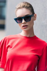 portrait of stylish young female model in sunglasses