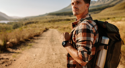 Thoughtful young man hiking in countryside
