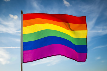 Gay pride rainbow flag flutters in the breeze.