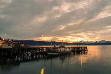 Fototapeta na wymiar landing stage at a small harbour in Narvik / Norway at midnight with midnight sun