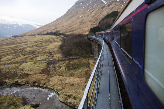 View from the window of a train moving through the Scottish countryside