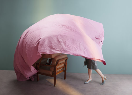woman playing with pink sheet