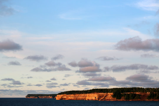 The Sandstone Cliffs Of Pictured Rocks National Lake Shore Glowing During A Summer Sunset