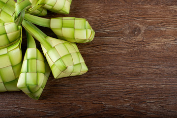 Ketupat or rice dumpling on wooden background. Copy space.