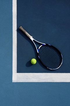 Racket and ball for tennis on corner