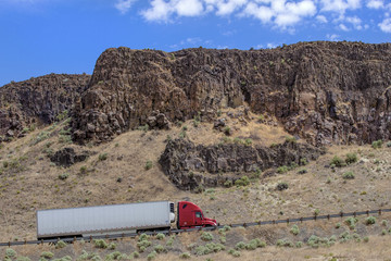Semi truck with trailer driving on highway
