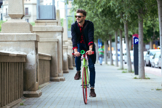 Handsome man riding bike in the city.