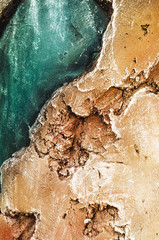 stone. Texture of a relief stone with a golden hue and azure color. wallpaper and background. vertical