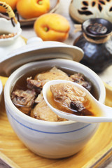 Black garlic chicken soup on the table 