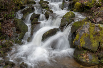 Water Rushing Over Mossy Boulders