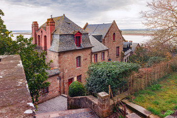 Fototapeta na wymiar The typical Norman houses inside the walls of Mont Saint Michel in the cloudy morning, Normandy, France