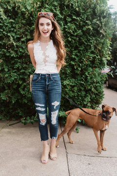 A young woman walking her dog