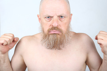 Obraz premium The aggressive bearded man with his fists
