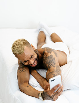 handsome tattooed man in bedroom