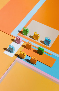 Colorful clocks on vibrant background.