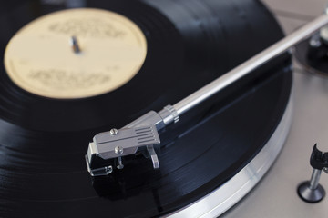 Record Player Tone Arm on a Spinning Vinyl Disc