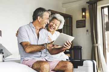 Mature couple using a tablet - Powered by Adobe