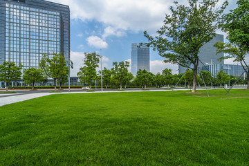 beautiful green field near modern office building. - Powered by Adobe