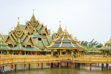 Fototapeta na wymiar gold and green vintage luxury pavilion was built on the pool, Muang Boran, Thailand.