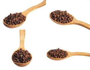 Dried carnations in a wooden spoon isolated on a white background