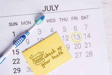 Calendar with a marked date and toothbrush.