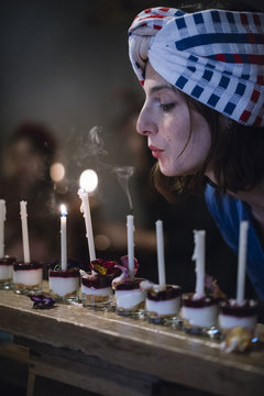 Young woman blowing candles