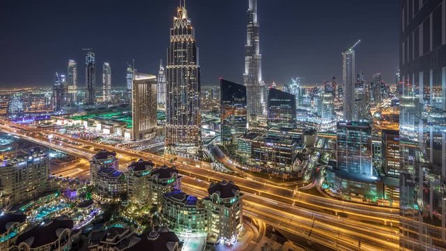 Dubai downtown skyline night timelapse with tallest building and road traffic, UAE