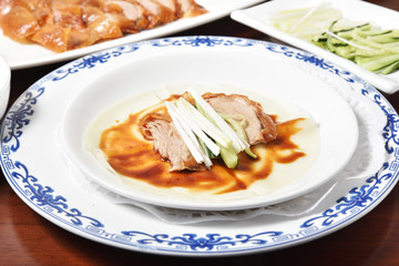 Peking Duck - Chinese roast duck served with  spring onion and hoisin sauce, wrapped in pancakes.      