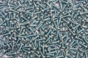 Screws as background, top view