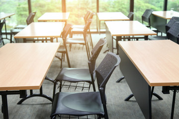 Table in a seminar room arranged in lined with chairs.