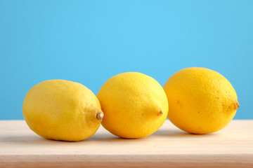 Lemon on wooden and blue background