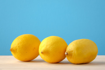 Lemon on wooden and blue background