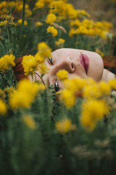 Red Haired Woman laying in flowers
