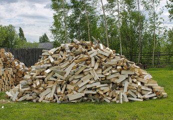 A mountain of chopped firewood for a stove in a village