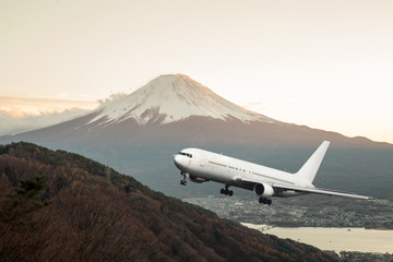 Airplane frying over the  Mountain Fuji background. Travel concept.
