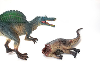 dinosaur bloody body and a spinosaurus at background selective focus