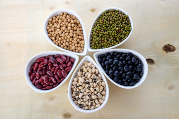 Healthy food, variety of beans. Mung beans black beans , soybean, red kidney , black eye peas on white ceramic bowl.