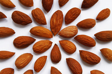 handful of peeled almonds on a white background
