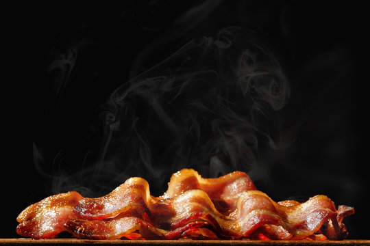 Pile of Sizzling Bacon Isolated on Black