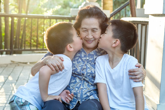 Happy Senior Asian Woman With Her Grandchildren