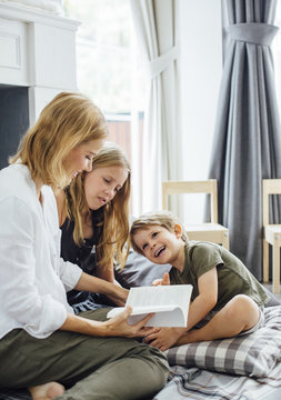 Mother Reading Book For Kids At Home